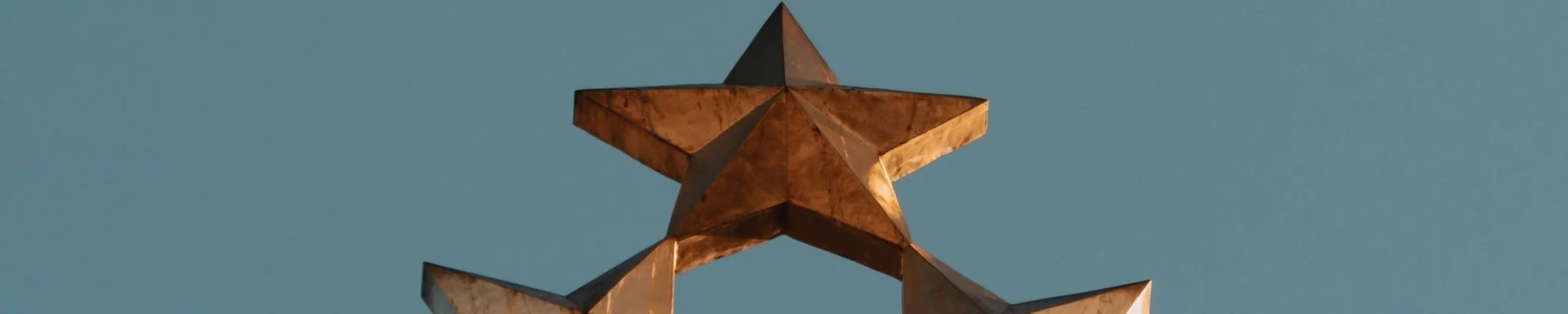 Gold metal stars against a blue background